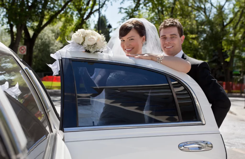  Book a Wedding Limo Service Chicago with ease, A bride an groom getting ready to enter the limo